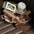 Assorted emi jay hair accessories and Aura Hair + Body Mist in Toasted Sugar with coffee in tray.