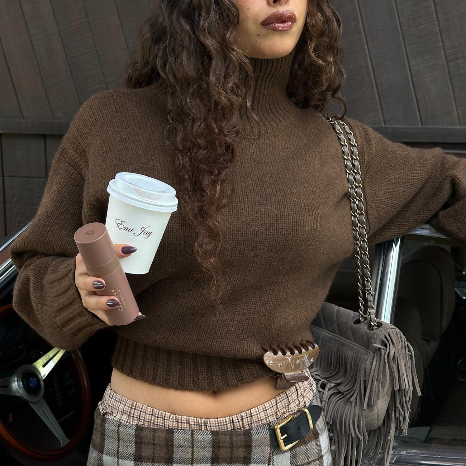 Model holding coffee and Aura Hair + Body Mist in Toasted Sugar with Big Effing Clip in Toasted Sugar clipped to sweater.